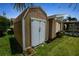 Exterior view of a home with an outdoor shed and nicely maintained lawn at 10 Venetian Cir, Port Orange, FL 32127