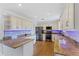 Updated kitchen with stainless steel appliances, granite countertops, and white cabinetry at 10 Venetian Cir, Port Orange, FL 32127