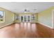 Bright living room featuring wood floors, a ceiling fan, and sliding glass doors at 10 Venetian Cir, Port Orange, FL 32127