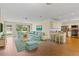 Open floor plan with hardwood floors, living area, and a kitchen island with barstool seating at 10 Venetian Cir, Port Orange, FL 32127