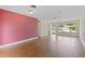 Empty living room with wood floors and a large picture window with a view of the outdoors at 10 Venetian Cir, Port Orange, FL 32127