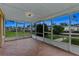 The enclosed tile patio offers views of palm trees, grass lawn, and water at 10 Venetian Cir, Port Orange, FL 32127