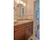 Bathroom vanity with a round mirror, wood cabinets, and modern fixtures at 1017 Chippewa Trl, Daytona Beach, FL 32117