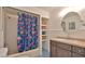 Bathroom with colorful curtain, vanity, and patterned blue tile floor at 1017 Chippewa Trl, Daytona Beach, FL 32117
