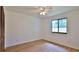 This bedroom features hardwood floors, a ceiling fan, and a window for natural light at 1017 Chippewa Trl, Daytona Beach, FL 32117