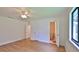 Spacious bedroom with ceiling fan, wood-look flooring, and an ensuite bathroom at 1017 Chippewa Trl, Daytona Beach, FL 32117