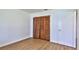 Bedroom featuring wood-look floors and bifold closet doors at 1017 Chippewa Trl, Daytona Beach, FL 32117