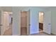 Hallway view showcasing a walk-in closet and a bathroom vanity with wood cabinets at 1017 Chippewa Trl, Daytona Beach, FL 32117