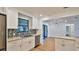 Updated kitchen with modern appliances, white cabinets, and mosaic tile backsplash at 1017 Chippewa Trl, Daytona Beach, FL 32117