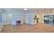 Open-concept living room featuring wood floors and seamless flow into kitchen space at 1017 Chippewa Trl, Daytona Beach, FL 32117