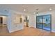 Open concept floor plan with view to the kitchen and sliding glass doors to the lanai at 1017 Chippewa Trl, Daytona Beach, FL 32117