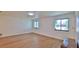 Bright living room featuring wood-look flooring, neutral walls, and natural light from large windows at 1017 Chippewa Trl, Daytona Beach, FL 32117