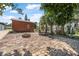 Large backyard with brick patio, fire pit, and mature trees at 1085 Indigo Rd, Ormond Beach, FL 32174