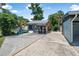 Backyard view showcasing a well-equipped outdoor kitchen, and a spacious driveway at 1085 Indigo Rd, Ormond Beach, FL 32174