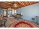 Spacious basement featuring a daybed, decorative rugs, and open ceiling at 1085 Indigo Rd, Ormond Beach, FL 32174