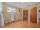 Bedroom showcasing hardwood floors, a window with sheer curtains, and a closet with wood doors at 1085 Indigo Rd, Ormond Beach, FL 32174