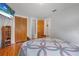Well-lit bedroom with closet, hardwood floors, and TV at 1085 Indigo Rd, Ormond Beach, FL 32174