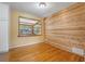 Bright dining room featuring hardwood floors and a unique wood-paneled accent wall at 1085 Indigo Rd, Ormond Beach, FL 32174