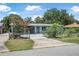 Charming single-story blue home featuring a metal roof, a fenced yard, and a spacious driveway at 1085 Indigo Rd, Ormond Beach, FL 32174