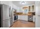 Cozy kitchen with stainless steel appliances and white cabinetry at 1085 Indigo Rd, Ormond Beach, FL 32174