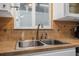 Close-up of the kitchen sink and faucet with decorative backsplash at 1085 Indigo Rd, Ormond Beach, FL 32174