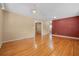 Spacious living room with beautiful hardwood floors, and view into the next room at 1085 Indigo Rd, Ormond Beach, FL 32174