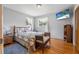 Bedroom showcasing a bed, side table, TV, wood floors, and natural light at 1085 Indigo Rd, Ormond Beach, FL 32174