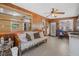 Cozy sunroom with wood paneling, a ceiling fan, and plenty of natural light from large windows at 1085 Indigo Rd, Ormond Beach, FL 32174