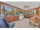 Bright sunroom filled with windows overlooking lush greenery at 1085 Indigo Rd, Ormond Beach, FL 32174