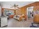 Cozy sunroom with wood-paneled walls and a view of the backyard at 1085 Indigo Rd, Ormond Beach, FL 32174