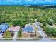 Aerial view showing the home's pool and the lush, surrounding landscape and neighborhood at 1104 W Seagate Dr, Deltona, FL 32725
