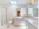 Bright bathroom with double sinks, a walk-in shower and a skylight at 1104 W Seagate Dr, Deltona, FL 32725