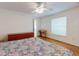 Bright bedroom with wood floors, a ceiling fan, and a window at 1104 W Seagate Dr, Deltona, FL 32725