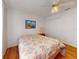 Comfortable bedroom featuring a ceiling fan, wood floors, and a cheerful floral bed covering at 1104 W Seagate Dr, Deltona, FL 32725