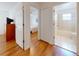 Hallway leading to bedroom and bathroom with wood flooring at 1104 W Seagate Dr, Deltona, FL 32725