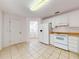Well-lit kitchen with white appliances, tile flooring, and plenty of cabinet space at 1104 W Seagate Dr, Deltona, FL 32725