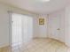 Bright, neutral space with tile flooring, vertical blinds and a glass door to the outside at 1104 W Seagate Dr, Deltona, FL 32725
