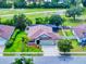 Aerial view of the home showcases lush landscaping, a screened-in pool, and a well-maintained yard at 112 Tuscany Bend St, Daytona Beach, FL 32117