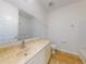 Bathroom with tan ceramic tile floors, a marble-look vanity, and a shower with a glass door at 112 Tuscany Bend St, Daytona Beach, FL 32117