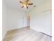 Bright bedroom with modern ceiling fan, neutral walls, light wood-look floors, and closet at 112 Tuscany Bend St, Daytona Beach, FL 32117