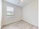 A bright bedroom featuring a window with blinds and wood-look floors at 112 Tuscany Bend St, Daytona Beach, FL 32117