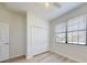 Bedroom with wood-look floors, a double-door closet, and a window with blinds at 112 Tuscany Bend St, Daytona Beach, FL 32117