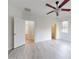 Well-lit bedroom with two doorways, light wood-look floors, and ceiling fan at 112 Tuscany Bend St, Daytona Beach, FL 32117
