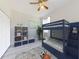 A bedroom with light-colored walls, wood-look floors, and a blue bunk bed at 112 Tuscany Bend St, Daytona Beach, FL 32117