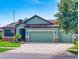 Charming home features a three-car garage, manicured lawn, and lovely curb appeal at 112 Tuscany Bend St, Daytona Beach, FL 32117