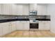 Updated kitchen with white cabinets, mosaic backsplash, stainless steel appliances, and tile flooring at 112 Tuscany Bend St, Daytona Beach, FL 32117