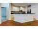 Bright kitchen boasts white cabinets, black granite countertops, and stainless steel appliances at 112 Tuscany Bend St, Daytona Beach, FL 32117