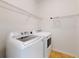 Bright laundry room featuring white appliances and wire shelving for efficient storage solutions at 112 Tuscany Bend St, Daytona Beach, FL 32117