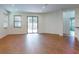 Spacious living area with wood floors, bright windows and sliding glass door to the patio at 112 Tuscany Bend St, Daytona Beach, FL 32117
