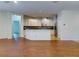 Open concept living room with wood floors, recessed lighting, and access to the kitchen and patio at 112 Tuscany Bend St, Daytona Beach, FL 32117